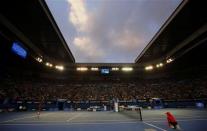 Rafael Nadal (L) of Spain serves to Roger Federer of Switzerland during their men's singles semi-final match at the Australian Open 2014 tennis tournament in Melbourne January 24, 2014. REUTERS/Petar Kujundzic