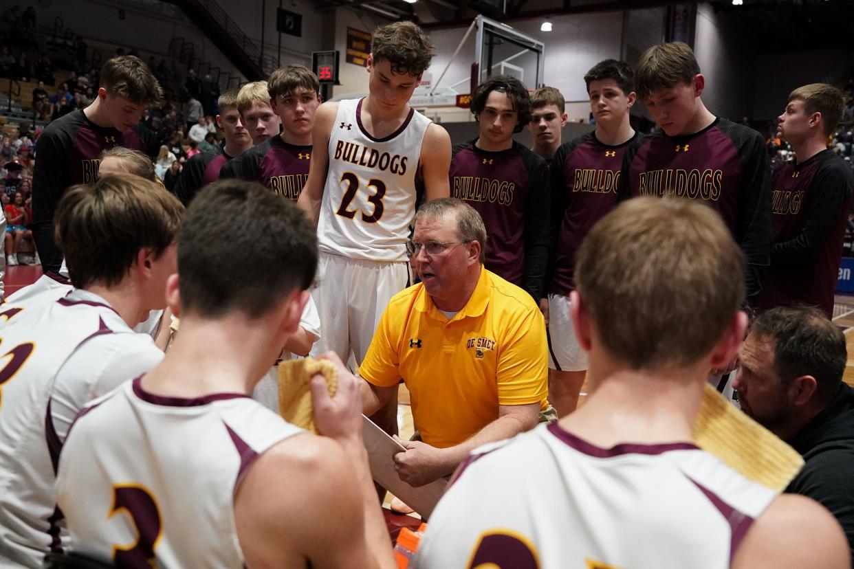 De Smet players listen to head coach Jeff Gruenhagen during their opening-round game in the state Class B boys basketball tournament on Thursday, March 14, 2024 in the Barnett Center at Aberdeen. Jensen's 3 over Mitchell with one second left lifted De Smet to a 41-38 win.