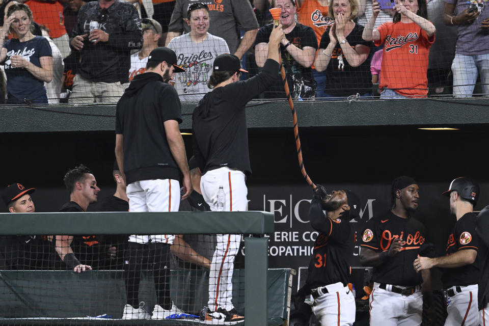 Baltimore Orioles' Cedric Mullins (31) drinks from the 'homer hose' after hitting a three-run home run against the Pittsburgh Pirates in the eighth inning of a baseball game, Friday, May 12, 2023, in Baltimore. (AP Photo/Gail Burton)