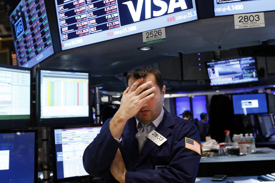 Specialist Vincent Surace works on the floor of the New York Stock Exchange Friday, Jan. 24, 2014. (AP Photo/Jason DeCrow)