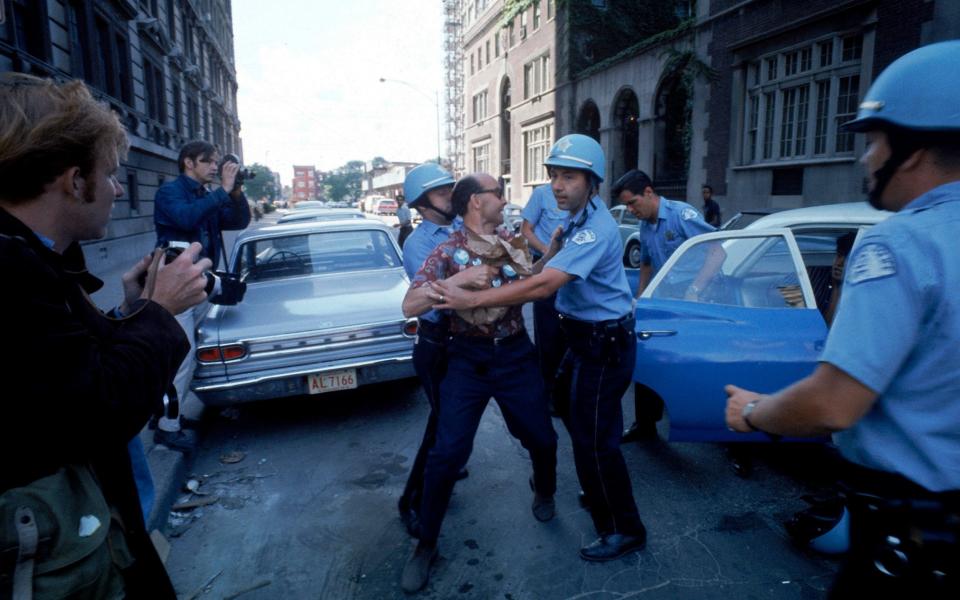 Police restrain a protester during the 1968 Democratic National Convention - Julian Wasser