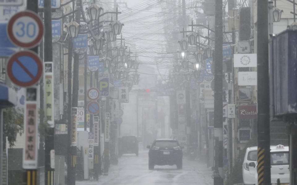 Vehicles make the way through heavy rain in Tanabe city, Wakayama prefecture, western Japan Tuesday, Aug. 15, 2023. A strong tropical storm lashed central and western Japan with heavy rain and high winds Tuesday, causing flooding and power blackouts and paralyzing air and ground transportation while many people were traveling for a Buddhist holiday week. (Kyodo News via AP)