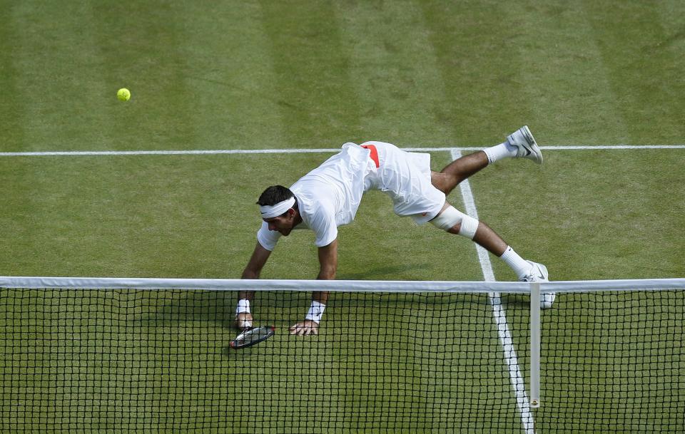 Argentina's Juan Martin Del Potro dives for the ball in his match against Serbia's Novak Djokovic during day eleven of the Wimbledon Championships at The All England Lawn Tennis and Croquet Club, Wimbledon.