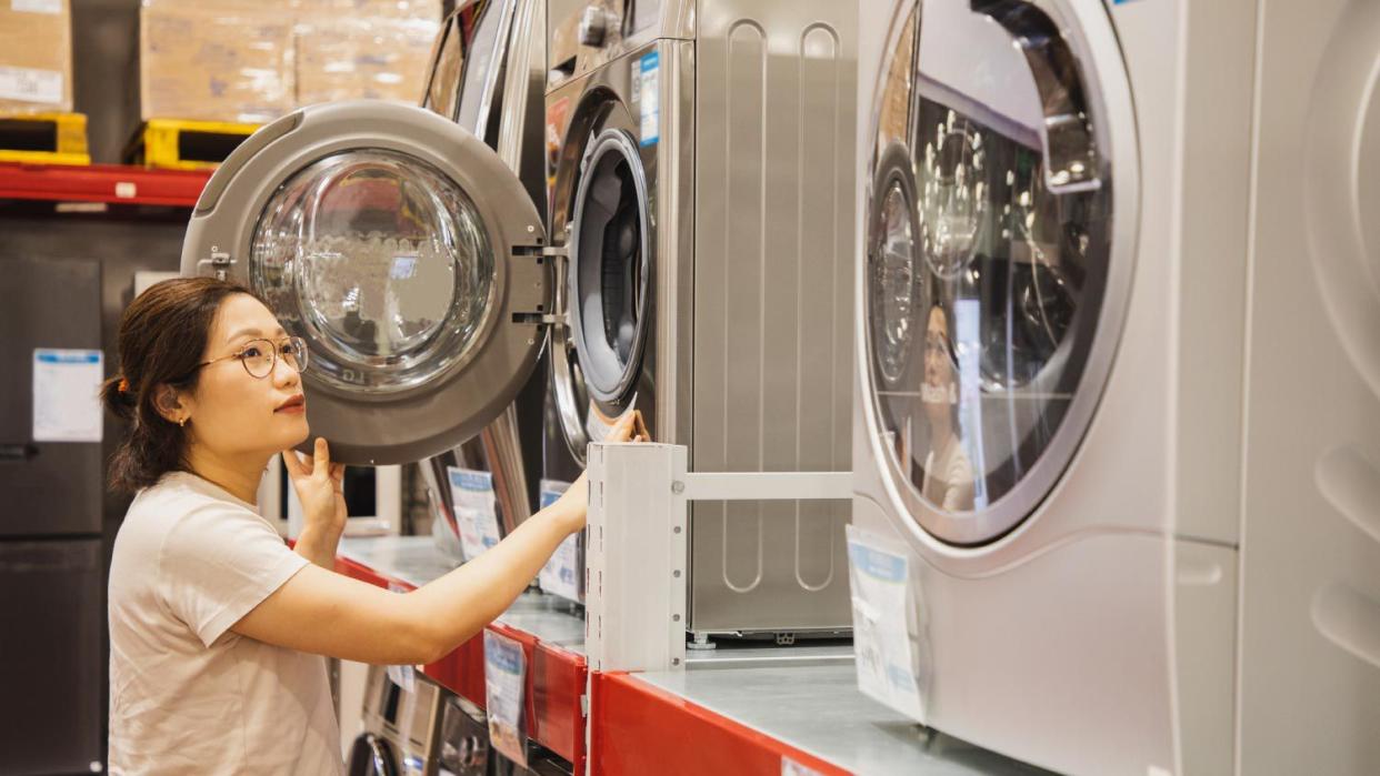 A woman shopping a washing machine