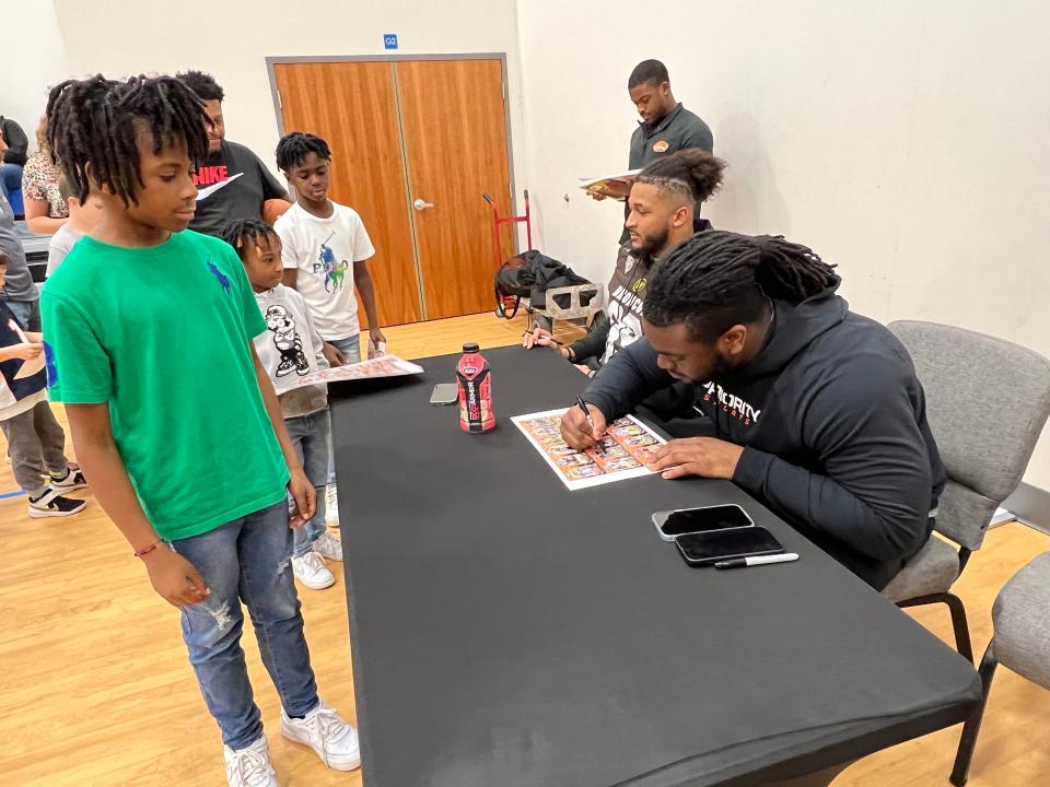 Navarre High grad and LSU defensive tackle Jordan Jefferson signs autographs for kids at Gateway Church of Christ during a visit Wednesday, Jan. 24, 2024, by Reese's Senior Bowl players.