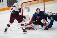 United States goalie Casey DeSmith (1) and Nick Bonino (13) defend the net in their bronze medal match against Latvia at the Ice Hockey World Championship in Tampere, Finland, Sunday, May 28, 2023. (AP Photo/Pavel Golovkin)