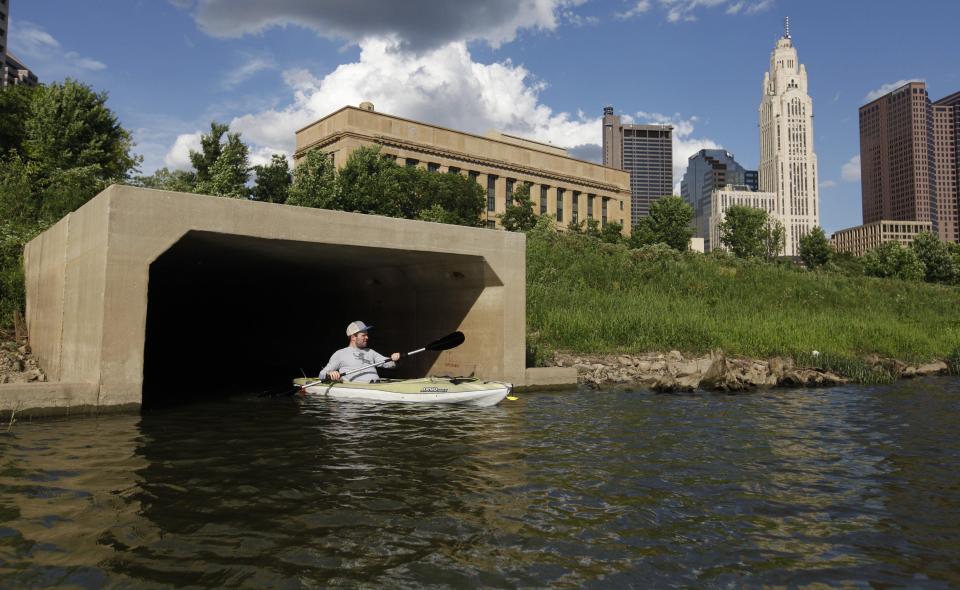 Dispatch Reporter Eric Lagatta rides out of a Downtown drainage culvert on the Scioto River in 2020.