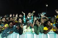 Laborers cheer at a fan festival at the Asian Town cricket stadium in Doha, Qatar, Friday, Nov. 25, 2022. Far from the luxury hotels and sprawling new stadiums emblematic of Doha during the World Cup, scores of soccer-mad South Asian workers poured into a converted cricket stadium in the city's desert outskirts to enjoy the tournament they helped create. (AP Photo/Jon Gambrell)