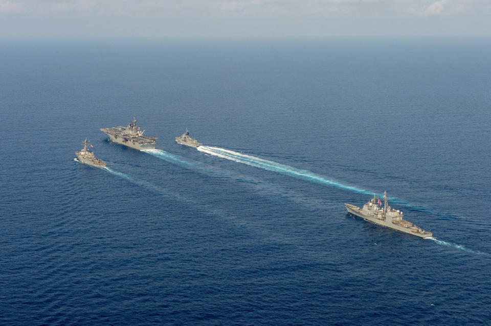 Image: RRoyal Australian Navy helicopter frigate HMAS Parramatta (top right) conducts officer of the watch manoeuvres with amphibious assault ship USS America, guided-missile destroyer USS Barry and guided-missile cruiser USS Bunker (Australia Department Of Defence / Reuters)