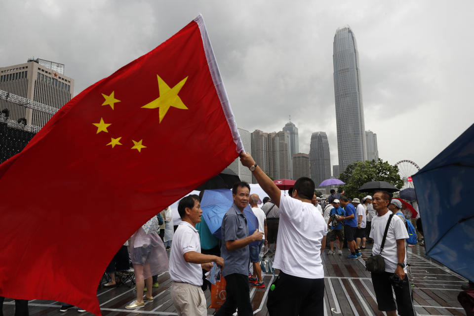 A pro-China supporter waves a Chinese national flag during a counter-rally in support of the police in Hong Kong Saturday, July 20, 2019. Police in Hong Kong have raided a homemade-explosives manufacturing lab ahead of another weekend of protests in the semi-autonomous Chinese territory.(AP Photo/Vincent Yu)