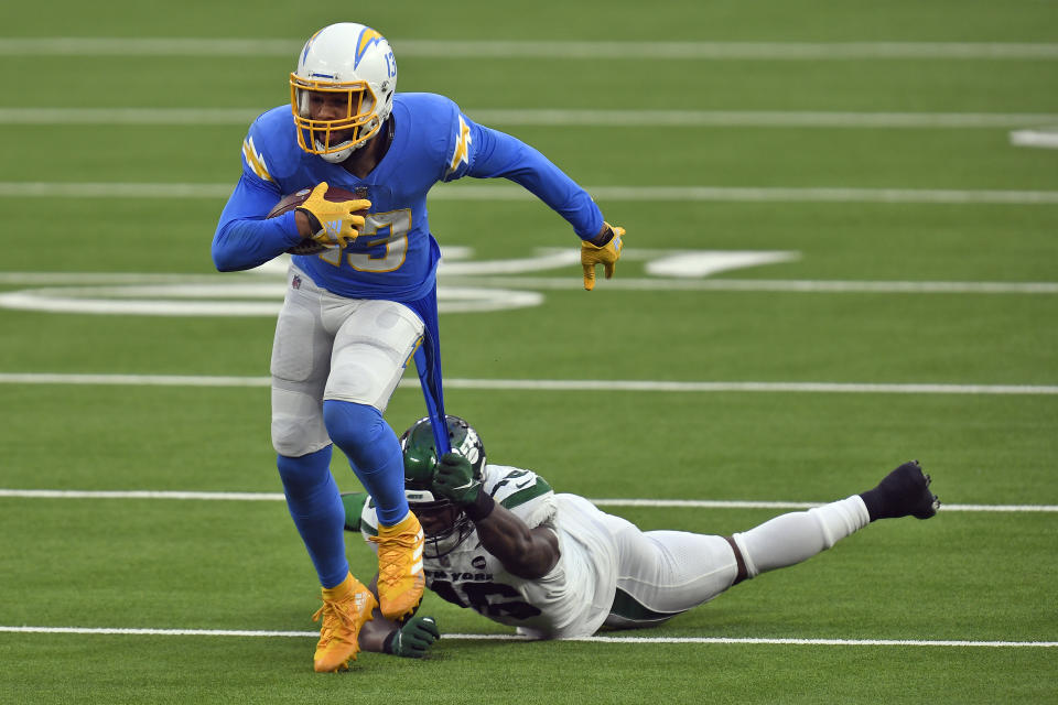 New York Jets linebacker Neville Hewitt, bottom, pulls on the jersey of Los Angeles Chargers wide receiver Keenan Allen after a catch by Allen during the second half of an NFL football game Sunday, Nov. 22, 2020, in Inglewood, Calif. (AP Photo/Kyusung Gong)