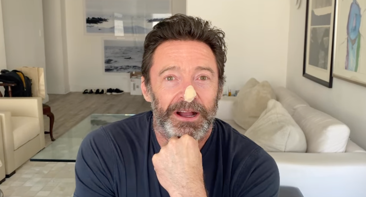 hugh jackman sitting in living room with bandage on nose following biopsy for basal cell carcinoma 