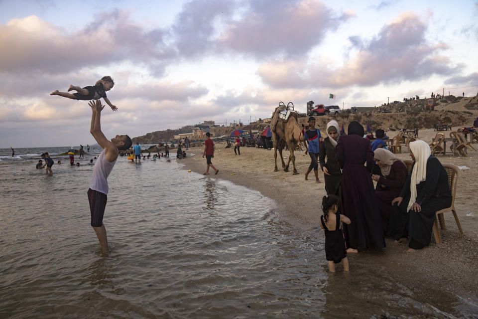 Palestinians enjoy the day on the beach in the Mediterranean Sea during a heat wave in Gaza City Sunday, July 23, 2023. (AP Photo/Fatima Shbair)