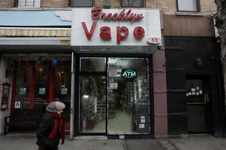 A woman walks by the Brooklyn Vape store in Brooklyn, New York, U.S., January 18, 2017. REUTERS/Joe Penney