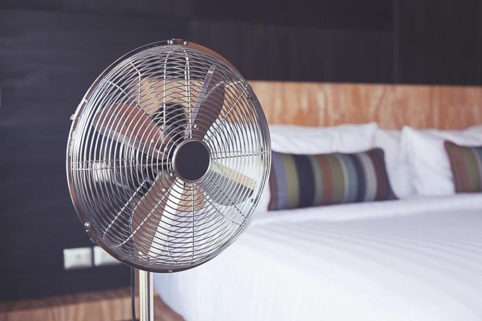 The increase in velocity of air flow from a fan makes the air, and you, feel cooler