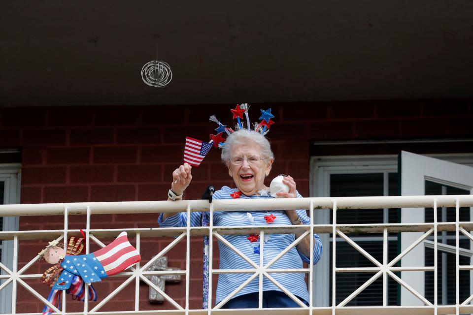 A quarantined resident at Lambeth House retirement community listens to opera singers in New Orleans on March 20, 2020.