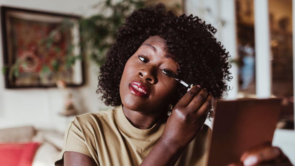 woman applying mascara