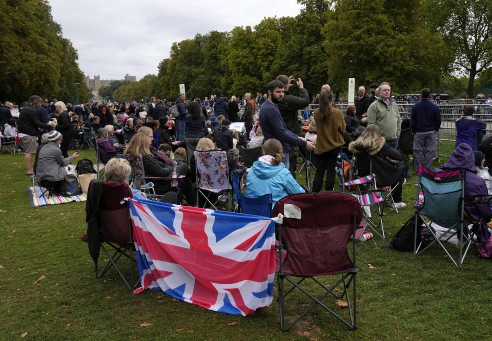 People wait along the Long Walk outside Windsor Castle for the coffin to arrive (Alastair Grant/PA) (PA Wire)