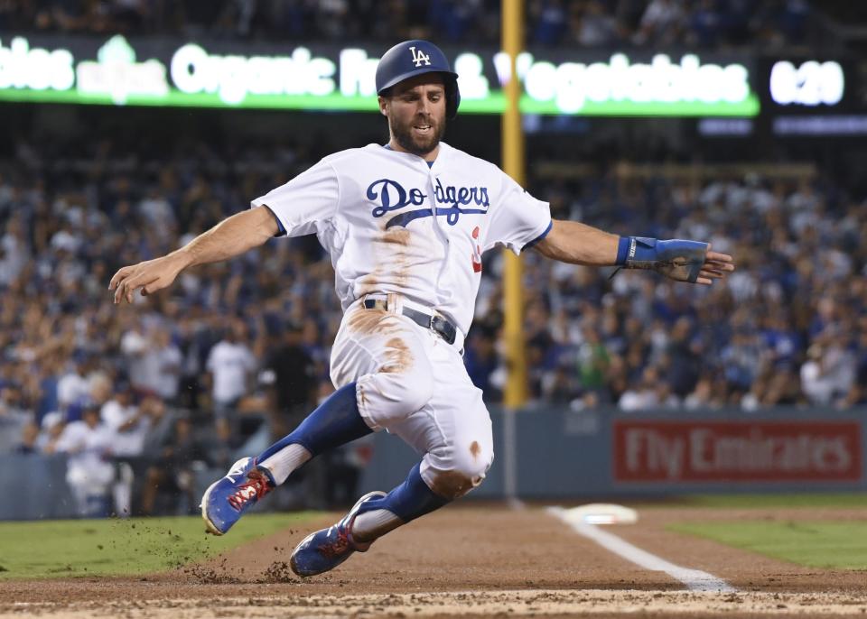 Los Angeles Dodgers' Chris Taylor scores during the first inning of Game 4 of the National League Championship Series baseball game against the Milwaukee Brewers Tuesday, Oct. 16, 2018, in Los Angeles. (AP Photo/Harry How, Pool)