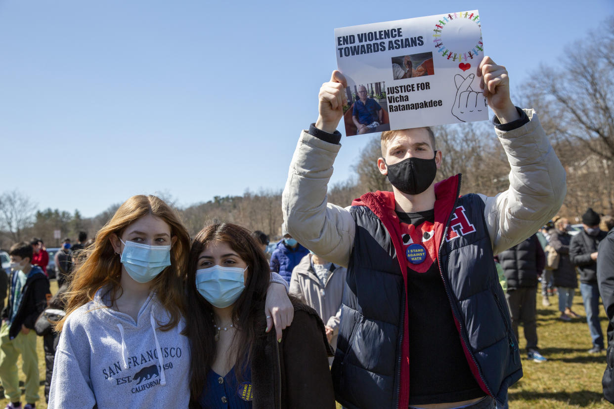 An attendee holds a sign that reads ''End Violence Towards Asians, Justice for Vicha Ratanapakdee'' at a rally organized by the Ardsley High School Asian Students Union against the Asian community in Ardsley, N.Y., in March 2021. (Gina M Randazzo/ZUMA Wire)