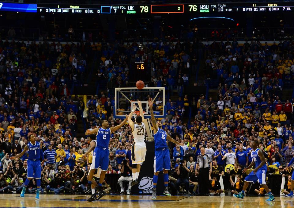 Wichita State guard Fred VanVleet takes a three-point shot while defended by Kentucky forward Willie Cauley-Stein (15) and Aaron Harrison (2) during their second-round game in the 2014 NCAA men's basketball tournament at Scottrade Center.