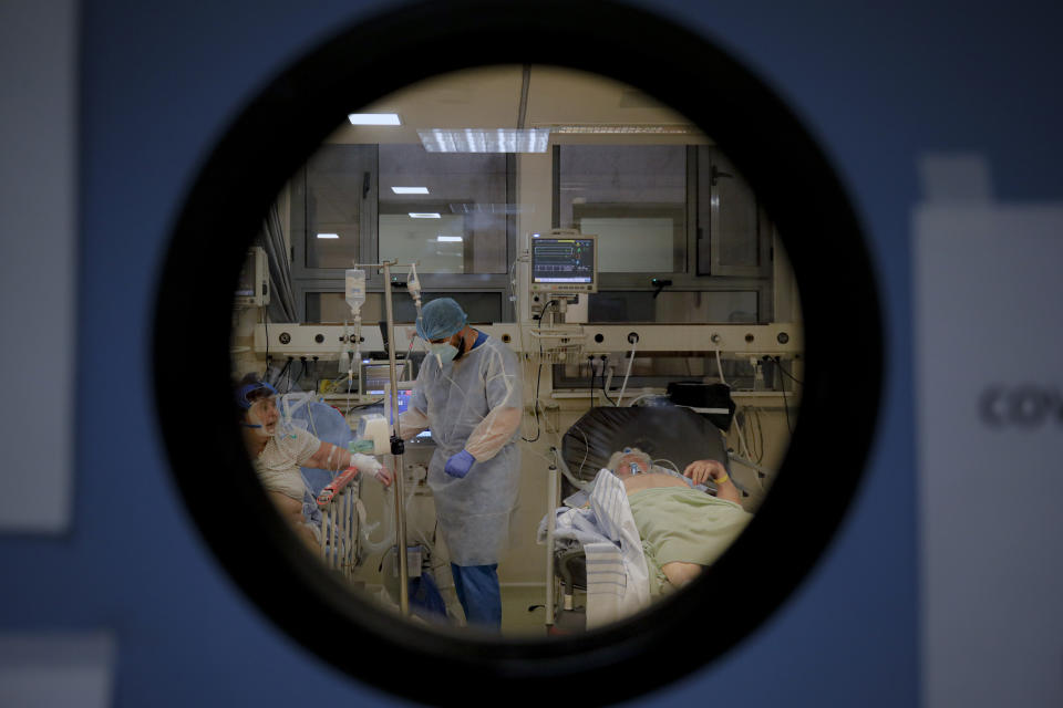Patients lie on beds in a COVID-19 isolation room at the University Emergency Hospital in Bucharest, Romania, Friday, Oct. 22, 2021. In Romania, a European Union country of around 19 million, only 35% of adults are fully inoculated against COVID-19 compared to an EU average of 74%. (AP Photo/Andreea Alexandru)