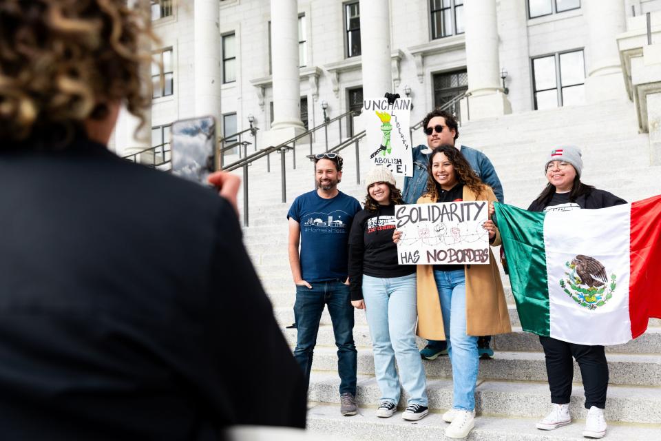 Attendees take photos with signs and flags at the “I Stand with All Immigrants Rally” in front of the Utah Capitol in Salt Lake City on Saturday, Oct. 28, 2023. | Megan Nielsen, Deseret News