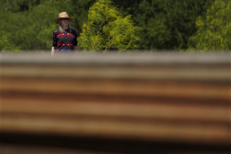 Molly Rooke checks on an abandoned well at her family ranch that was being plugged, Tuesday, May 18, 2021, near Refugio, Texas. Rooke, who co-owns the family ranch had an orphaned well blow out on her property, spewing chemicals into the air. The 15,000-acre ranch contained dozens of orphaned, unplugged wells, with pipes not much taller than her own frame. (AP Photo/Eric Gay)