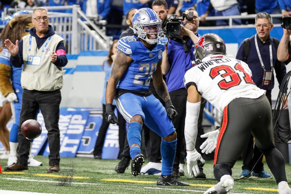 Detroit Lions running back Jahmyr Gibbs (26) celebrates a touchdown against Tampa Bay Buccaneers safety Antoine Winfield Jr. (31) during the second half of the NFC divisional round at Ford Field in Detroit on Sunday, Jan. 21, 2024.