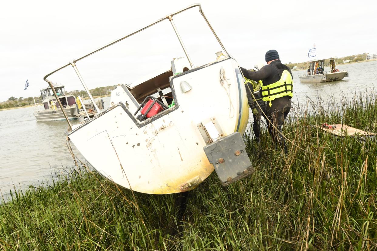 A bill in Raleigh would provide funds for the N.C. Coastal Federation to continue efforts to remove derelict boats and other debris in coastal waters. Here, an abandoned boat is moved from the Intracoastal Waterway in New Hanover County in March 2021.