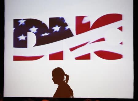 A woman is silhouetted against a projected image of the Democratic National Committee during its Rules and Bylaws Committee meeting in Washington May 31, 2008. REUTERS/Jason Reed