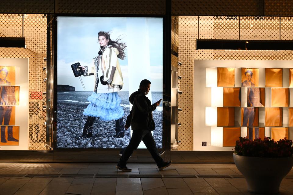 A man walks past a Louis Vuitton store in Beijing on October 27, 2021. (Photo by GREG BAKER / AFP) (Photo by GREG BAKER/AFP via Getty Images)