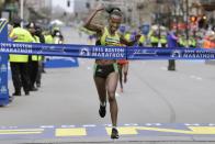 FILE - In this April 20, 2015, file photo, Caroline Rotich, of Kenya, crosses the finish line to win the women's division of the Boston Marathon in Boston. Due to the COVID-19 virus pandemic, the 124th running of the Boston Marathon was postponed from its traditional third Monday in April to Monday, Sept. 14, 2020. (AP Photo/Elise Amendola, File)