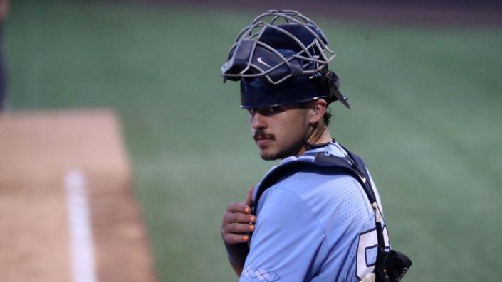 North Carolina catcher Tomas Frick checks with the dugout during the Tar Heels’ victory over VCU on Monday night in the NCAA baseball tournament.