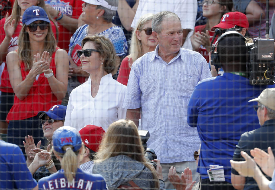 Former first lady Laura Bush, center left, and former President George W. Bush, center right, stand after being introduced in the fifth inning of a baseball game between the New York Yankees and Texas Rangers in Arlington, Texas, Sunday, Sept. 29, 2019. (AP Photo/Tony Gutierrez)