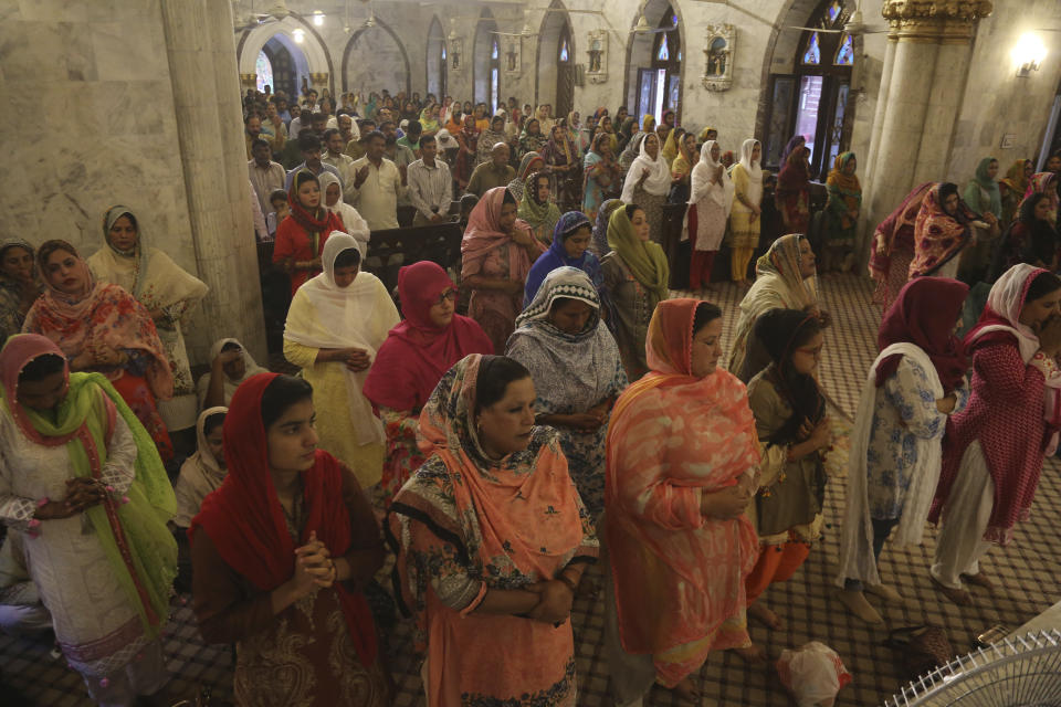 Pakistani Christians attend special prayers for the victims of bomb explosions in churches and hotels in Sri Lanka, in Lahore, Pakistan, Tuesday April 23, 2019. The death toll from the Easter Sunday bombings in Sri Lanka, rose Tuesday to more than 300. (AP Photo/K.M. Chaudary)