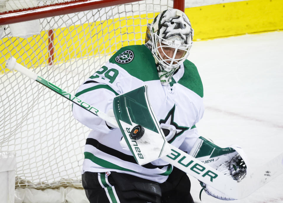 Dallas Stars goalie Jake Oettinger makes a save during first period NHL playoff hockey action against the Calgary Flames in Calgary, Alberta, Sunday, May 15, 2022. (Jeff McIntosh/The Canadian Press via AP)