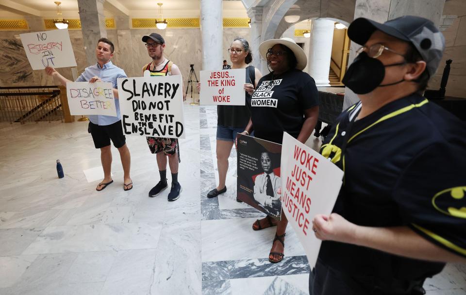 A handful of protesters hold signs during a press conference with Florida Gov. and presidential candidate Ron DeSantis at the Capitol in Salt Lake City on Friday, July 21, 2023. | Jeffrey D. Allred, Deseret News