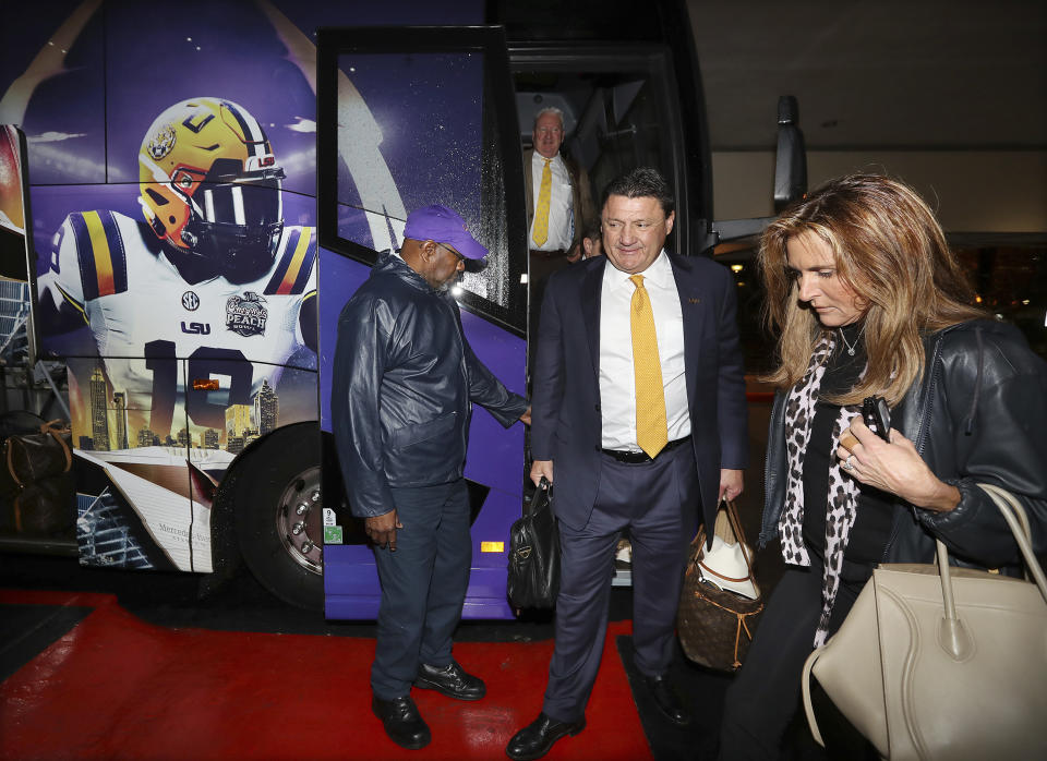 LSU head coach Ed Orgeron and his wife Kelly arrive with the team for the CFP Peach Bowl on Sunday, Dec. 22, 2019, in Atlanta. (Curtis Compton/Atlanta Journal-Constitution via AP)