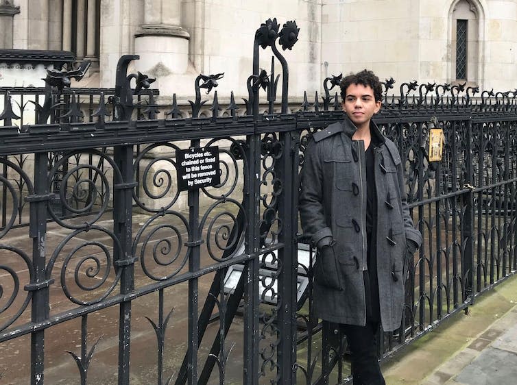 Keira Bell in front of railings at the Royal Courts of Justice