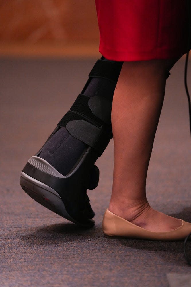 Gov. Katie Hobbs wears a walking boot as she answers questions during a press conference at the Arizona Capitol on Friday, Jan. 20, 2023, in Phoenix.