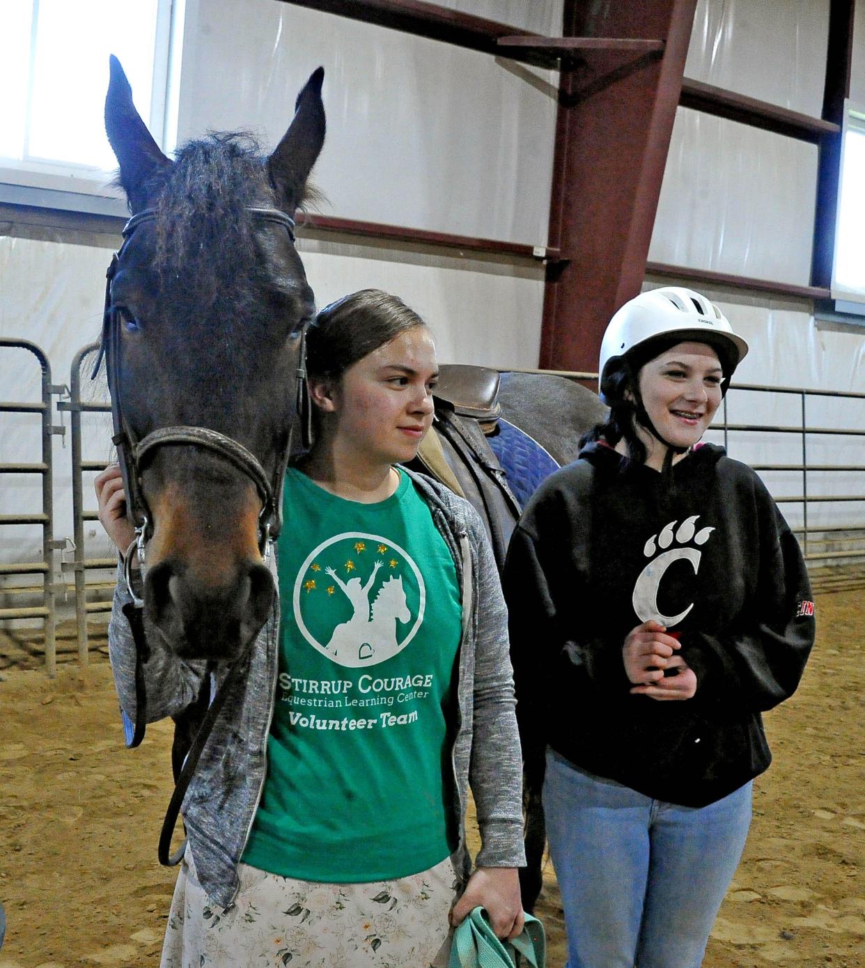 Stirrup Courage volunteer Cherllyn Penrod and client Aubree Vierheller are ready to take a theraputic horse ride.
