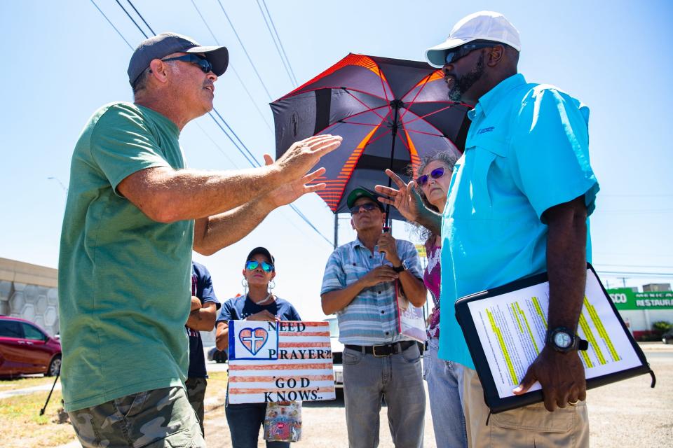 Samuel Aundrá Fryer, right, debates with a protester against County Citizens Defending Freedom at 10309 South Padre Island Drive on Saturday, July 9, 2022. CCDF, a conservative action group, offered instruction to community members on how to monitor and influence curriculum on topics such as education in local schools.
