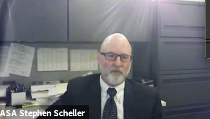 In this screen grab from live stream video, Lake County Assistant State's Attorney Stephen Scheller speaks to Judge Paul Novak during a hearing at the Nineteenth Judicial Circuit Court in Waukegan, Ill., on Friday, Oct. 9, 2020, in the case against Kyle Rittenhouse. Rittenhouse who is accused of killing two protesters days after Jacob Blake was shot by police in Kenosha, Wis., is fighting his return to Wisconsin to face homicide charges. (Nineteenth Judicial Circuit Court via AP)