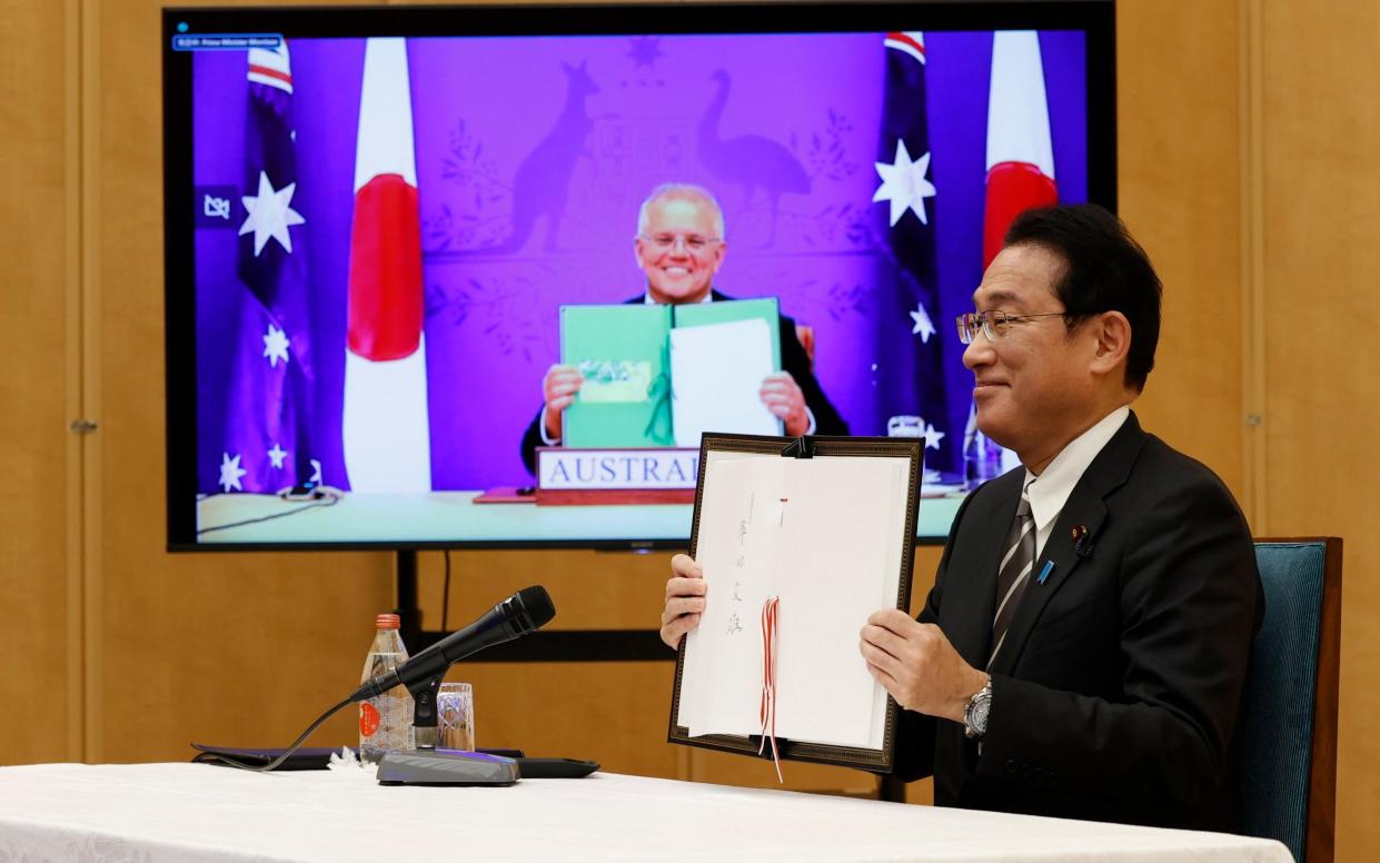 Fumio Kishida, Japan's prime minister, and Scott Morrison, his Australian counterpart, at a virtual summit where they signed the Reciprocal Access Agreement - Issei Kato/Reuters/AP