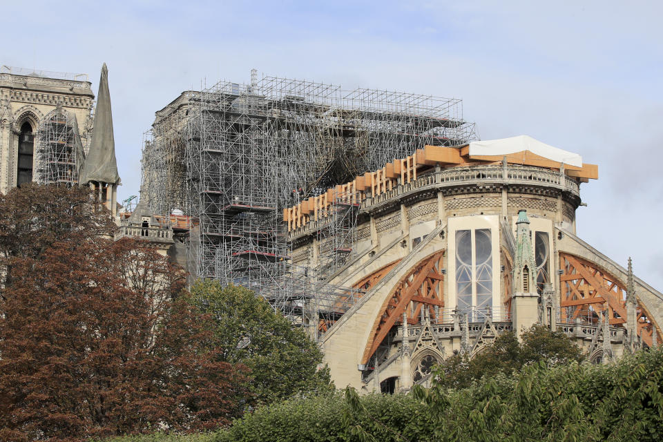 Notre Dame cathedral is pictured Tuesday, Oct. 15, 2019 in Paris. French Culture Minister Franck Riester said the melted, twisted scaffolding atop Notre Dame Cathedral will be removed "in coming weeks" to allow restoration work to begin. It's been six months since fire gutted the medieval structure, which was under renovation at the time and crisscrossed with scaffolding where the spire once stood. (AP Photo/Michel Euler)