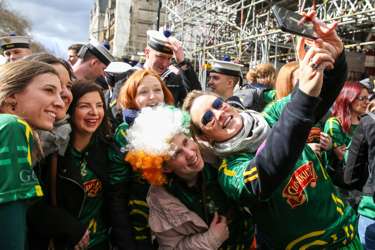 People are seen taking a selfie during the St Patrick's Day celebration as the annual parade travels through the streets of central London. (Photo by Dinendra Haria / SOPA Images/Sipa USA)