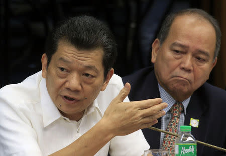 Chinese-born Filipino businessman Kam Sin Wong (L) gestures as he sits next to his lawyer Victor Fernandez, while answering questions during the money laundering hearing at Senate in Manila March 29, 2016. REUTERS/Romeo Ranoco