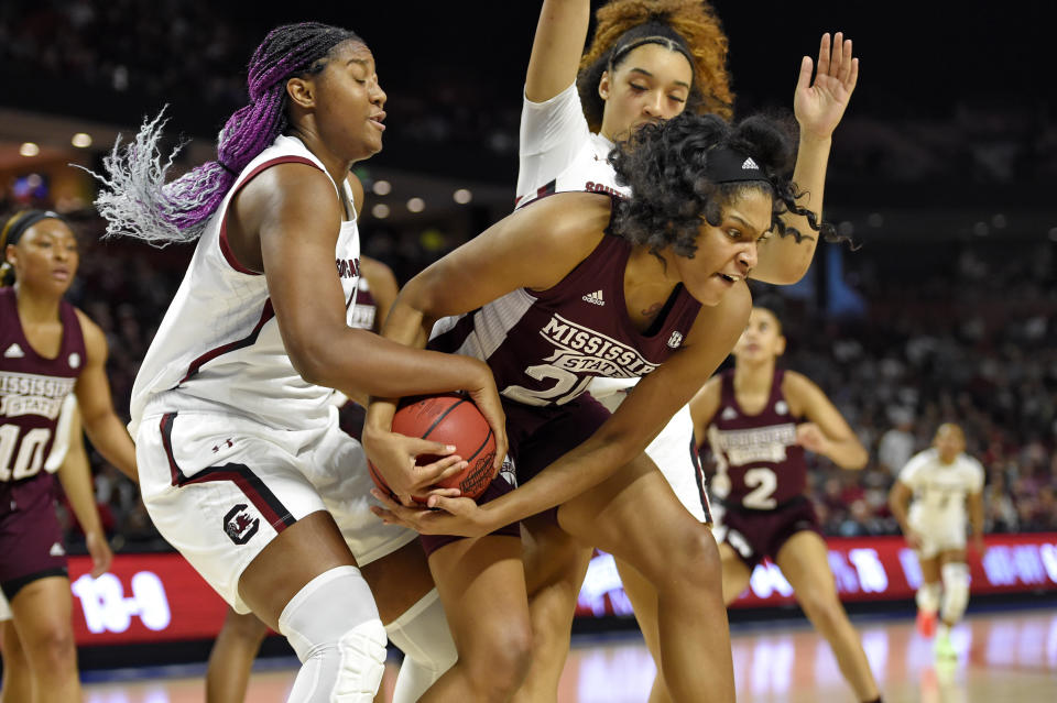 South Carolina's Aliyah Boston, left, and Mississippi State's Yemiyah Morris, right, battle for the ball during a championship match at the Southeastern Conference women's NCAA college basketball tournament in Greenville, S.C., Sunday, March 8, 2020. (AP Photo/Richard Shiro)