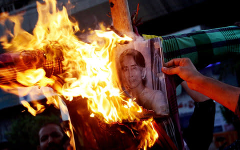 Protestors burn an effigy of Aung San Suu Kyi in Karachi, Pakistan - Credit: EPA/SHAHZAIB AKBER
